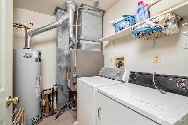 clothes washing area featuring laundry area, washing machine and dryer, and water heater