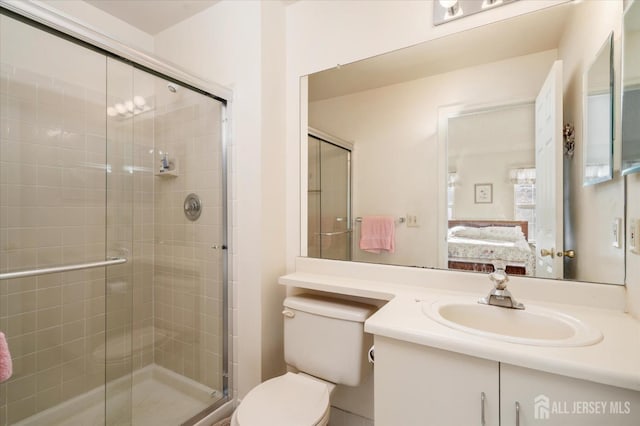 ensuite bathroom with toilet, a stall shower, vanity, and ensuite bath