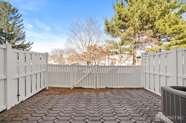 view of patio with central AC and fence