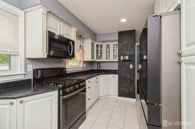 29 De Stefano Ave, Spotswood, NJ 08884 - kitchen with stainless steel appliances, light tile patterned floors, glass insert cabinets, white cabinets, and recessed lighting