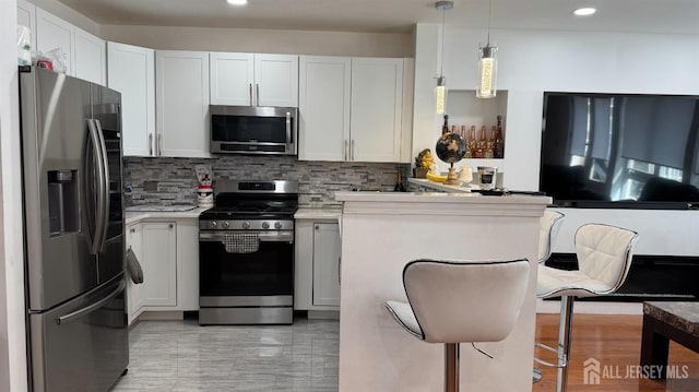 368 Rector St Unit 512, Perth Amboy, NJ 08861 - kitchen featuring stainless steel appliances, backsplash, recessed lighting, light countertops, and white cabinets
