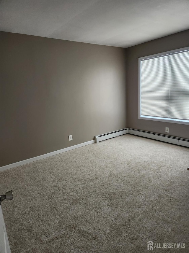 spare room with carpet and baseboards