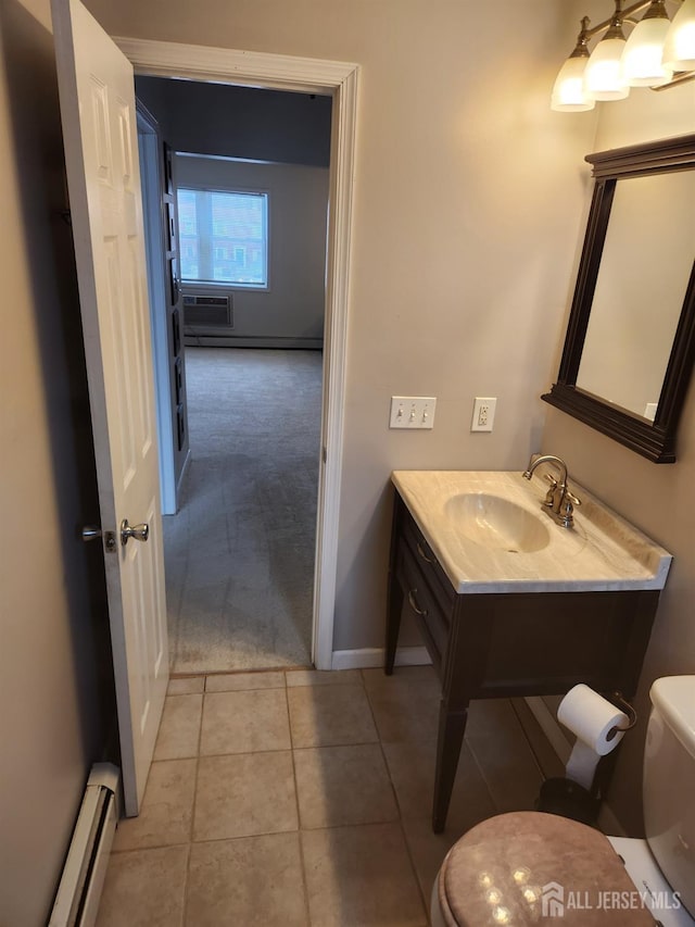 bathroom featuring a wall unit AC, tile patterned flooring, toilet, a baseboard heating unit, and vanity