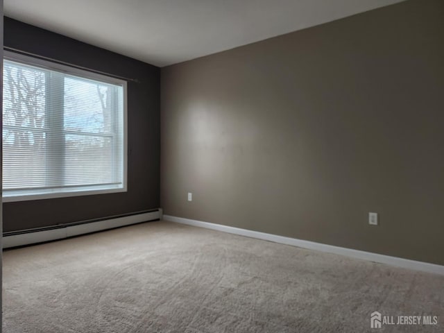 carpeted empty room featuring a baseboard radiator and baseboards