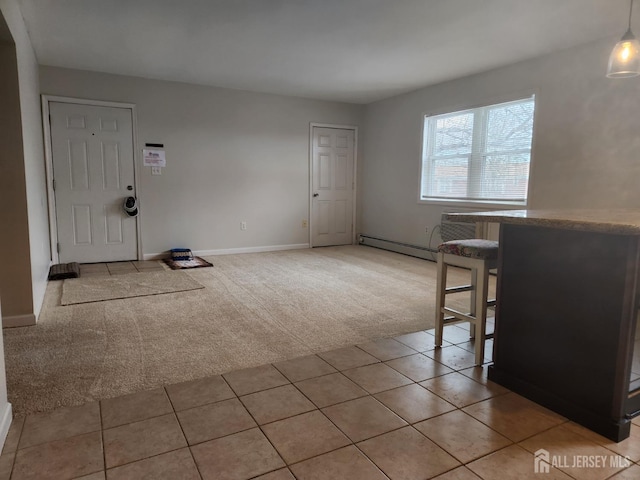 unfurnished dining area featuring light carpet, light tile patterned floors, baseboards, and baseboard heating