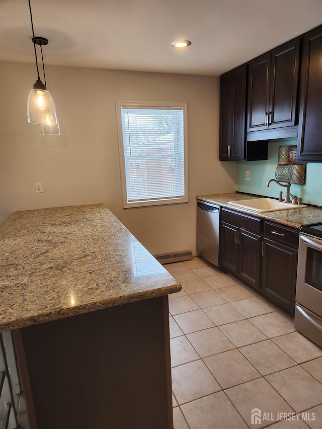 kitchen featuring light tile patterned floors, hanging light fixtures, stainless steel appliances, a baseboard heating unit, and a sink