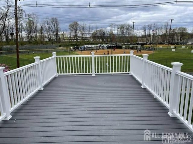 wooden deck with a lawn