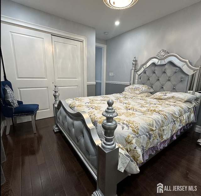 bedroom featuring a closet, recessed lighting, and dark wood-type flooring