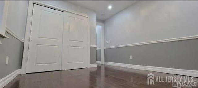 interior space with baseboards, a closet, recessed lighting, and wood finished floors