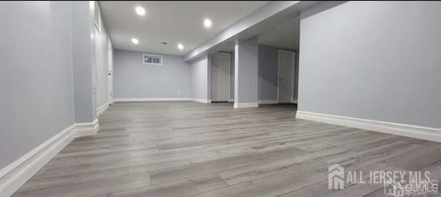 interior space featuring baseboards, recessed lighting, and wood finished floors