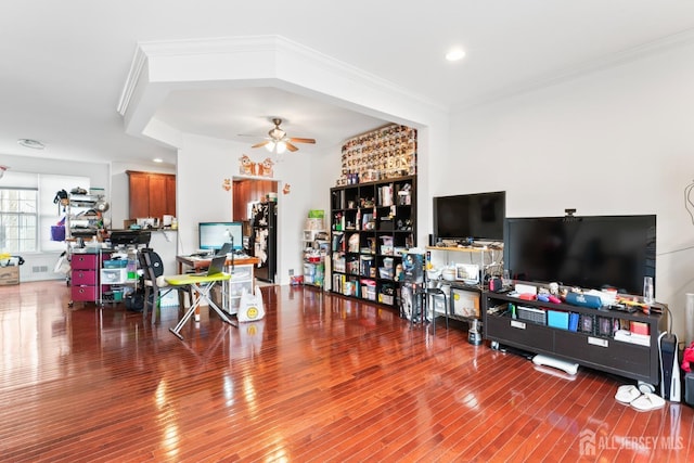 living room with wood finished floors, ceiling fan, ornamental molding, and recessed lighting