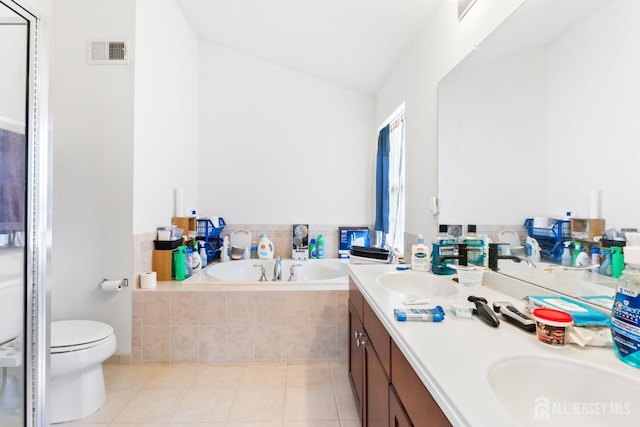 full bathroom featuring visible vents, a sink, double vanity, tile patterned floors, and a garden tub