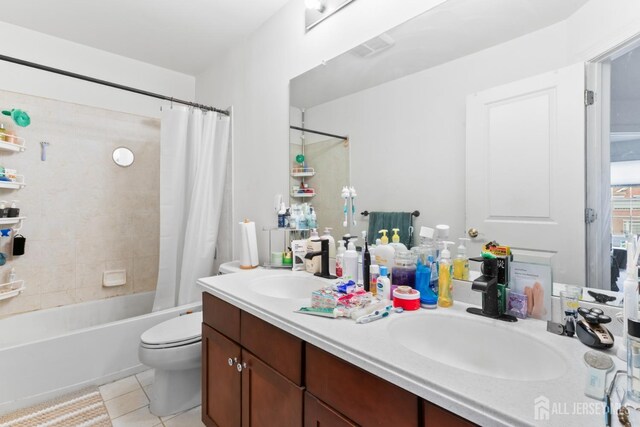 bathroom featuring double vanity, tile patterned flooring, shower / tub combo, and a sink