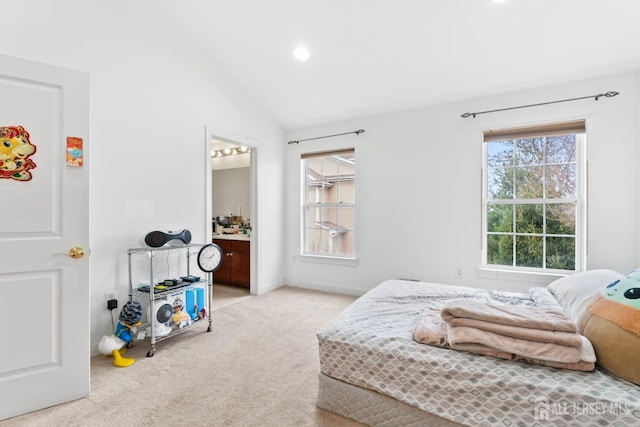 bedroom with recessed lighting, vaulted ceiling, connected bathroom, and light carpet