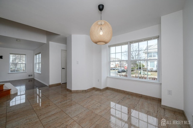 empty room featuring baseboards