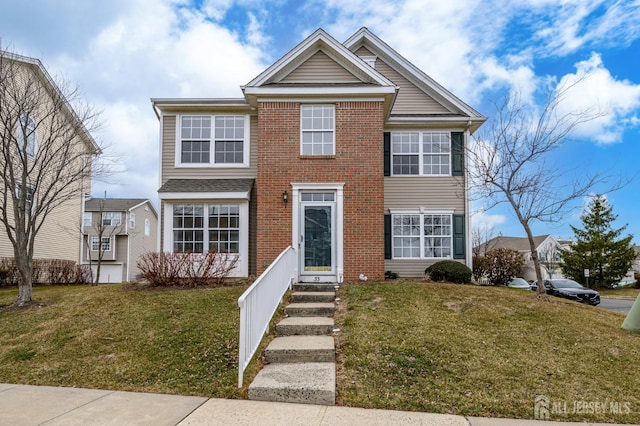 view of front of property with a front lawn and brick siding