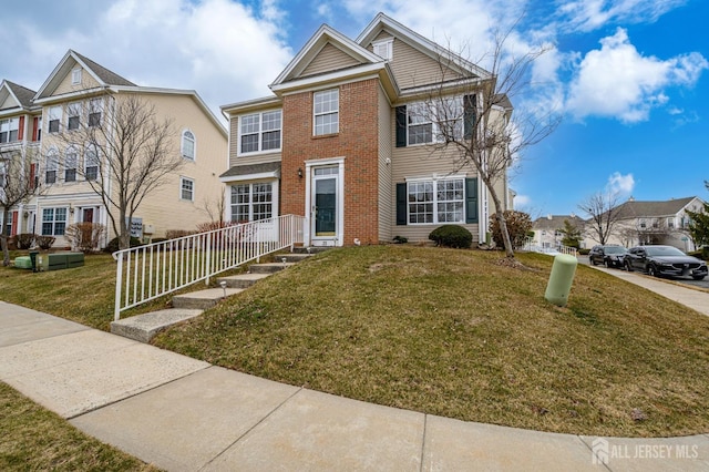 view of front of property with brick siding and a front lawn