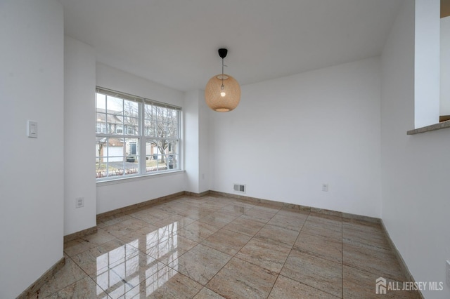 unfurnished dining area featuring visible vents and baseboards