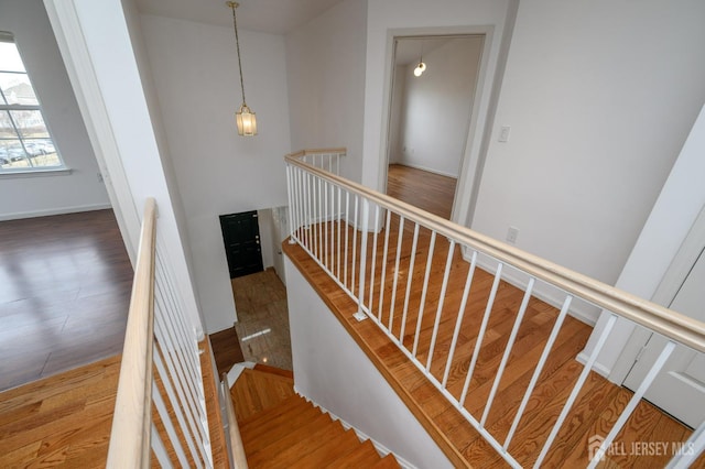 stairs with baseboards and wood finished floors