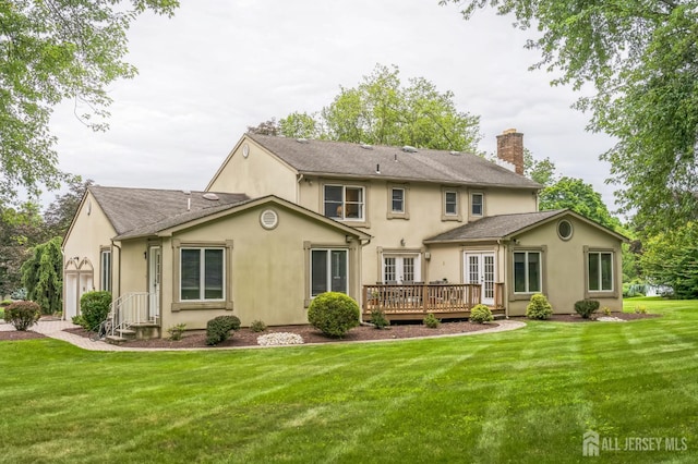 14 Greensview Dr, Scotch Plains, NJ 07076 - back of house with french doors, a deck, stucco siding, a chimney, and a lawn