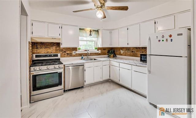 7402 Hana Rd, Edison, NJ 08817 - kitchen with appliances with stainless steel finishes, light countertops, white cabinetry, and decorative backsplash