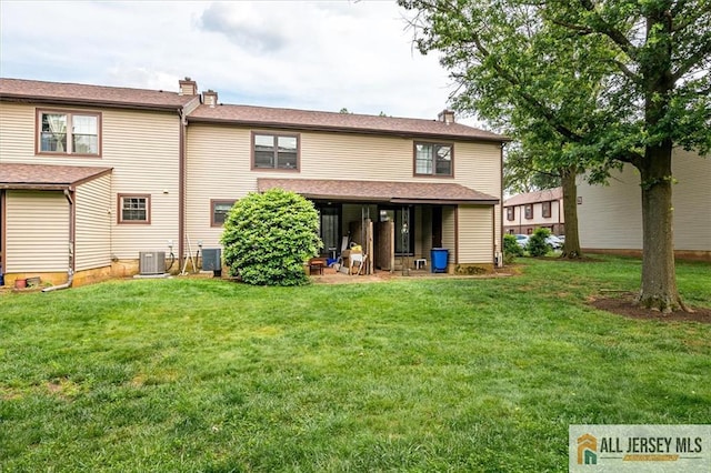 7402 Hana Rd, Edison, NJ 08817 - rear view of property featuring a lawn and a chimney