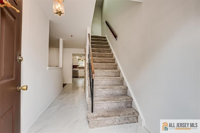 7402 Hana Rd, Edison, NJ 08817 - stairway featuring marble look tile flooring and baseboards