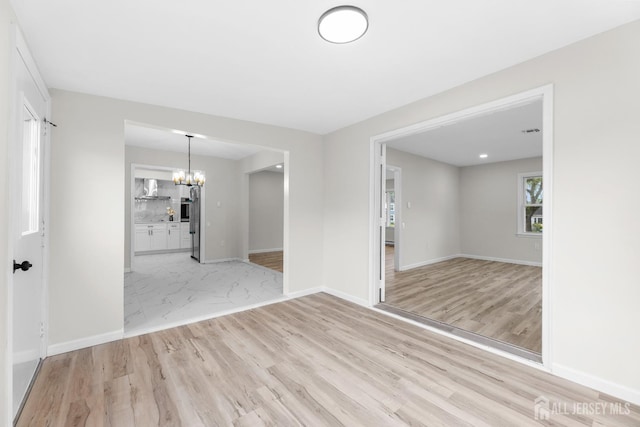 381-C Old Nassau Rd, Monroe, NJ 08831 - spare room featuring a chandelier and light wood-style flooring