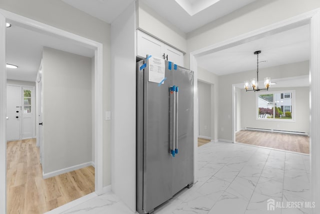 381-C Old Nassau Rd, Monroe, NJ 08831 - hallway with a baseboard heating unit, light marble finish floors, plenty of natural light, and a chandelier