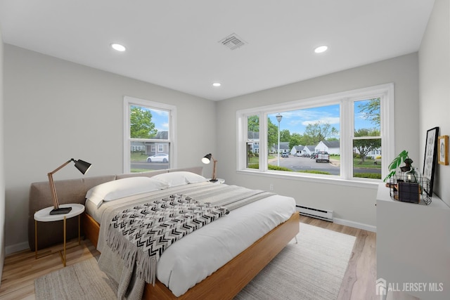 381-C Old Nassau Rd, Monroe, NJ 08831 - bedroom with baseboard heating, light wood finished floors, and recessed lighting