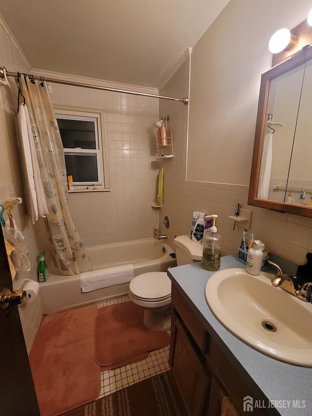 full bathroom with toilet, shower / tub combo with curtain, tile walls, tile patterned floors, and vanity