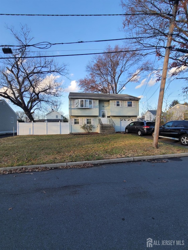 view of front facade featuring a front yard and a garage