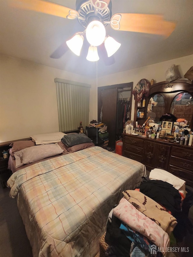 bedroom featuring ceiling fan and a closet