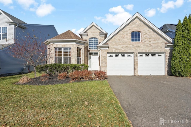 view of front property featuring a garage and a front yard