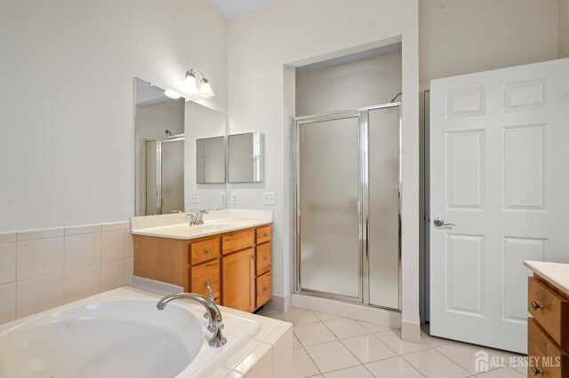 bathroom with tile patterned floors, plus walk in shower, and vanity