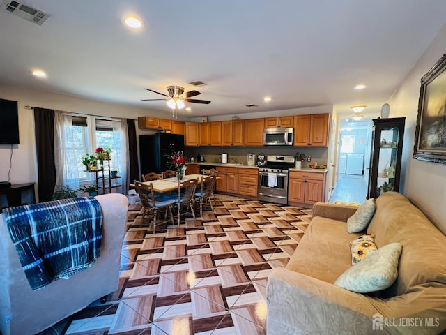 kitchen featuring stainless steel appliances, light countertops, recessed lighting, and a ceiling fan