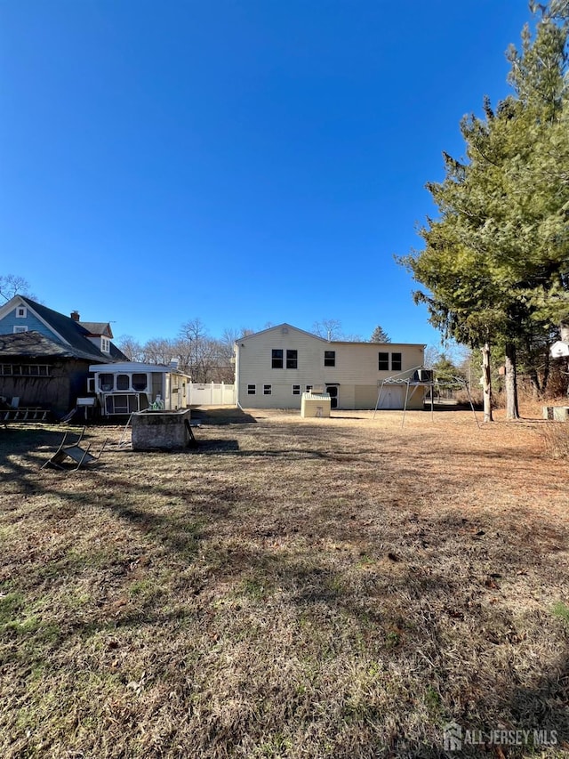 rear view of property with fence