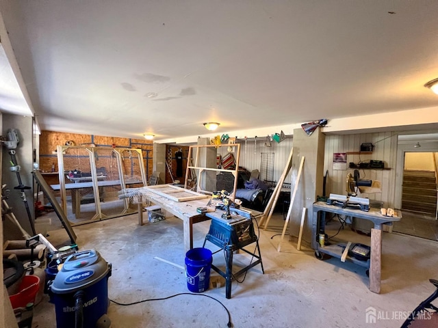 interior space with a workshop area and unfinished concrete flooring