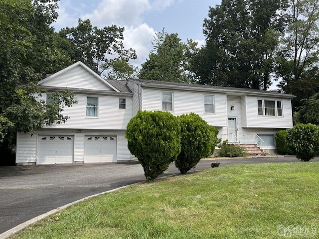 split foyer home with a garage and a front yard