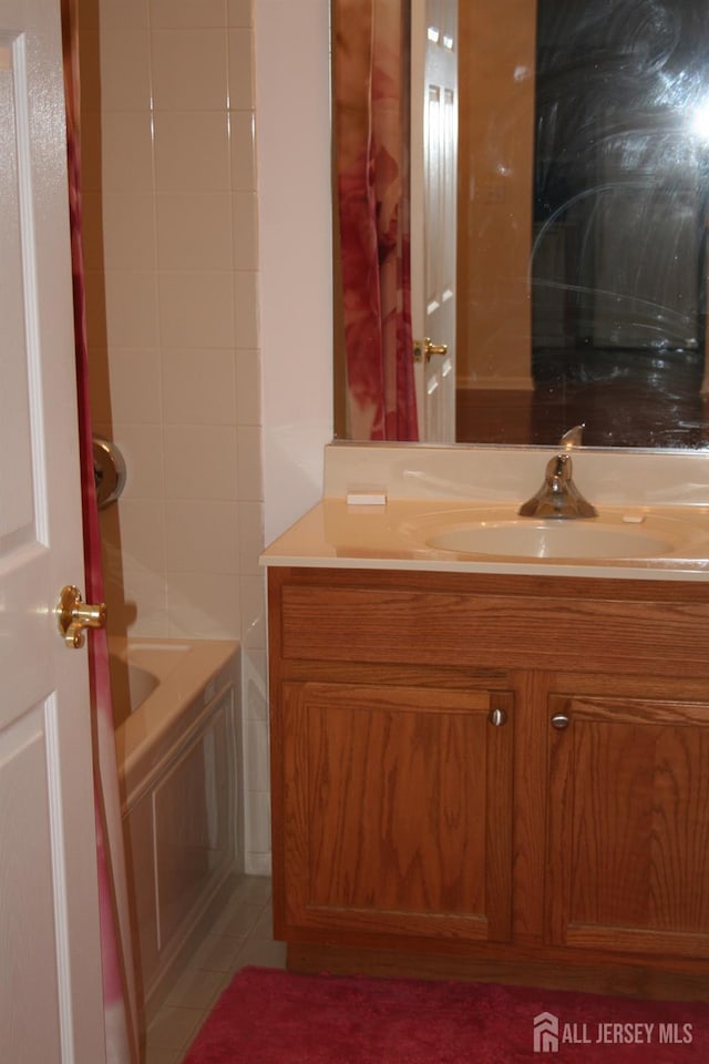 bathroom with vanity and a tub