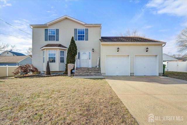 view of property with a garage and a front yard