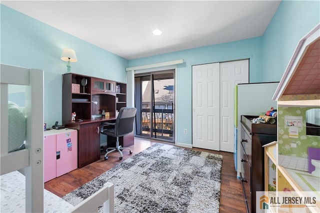 home office with dark hardwood / wood-style flooring