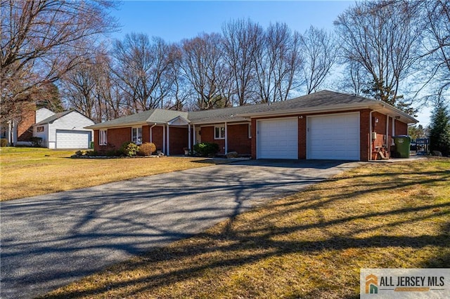 ranch-style house with brick siding, driveway, an attached garage, and a front lawn