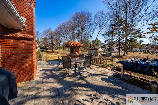 wooden deck with a patio area, grilling area, outdoor dining space, and fence