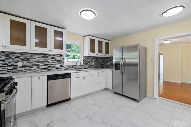 kitchen featuring decorative backsplash, a sink, stainless steel appliances, light countertops, and marble finish floor