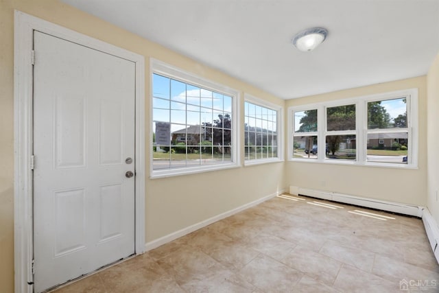 unfurnished sunroom with a baseboard heating unit