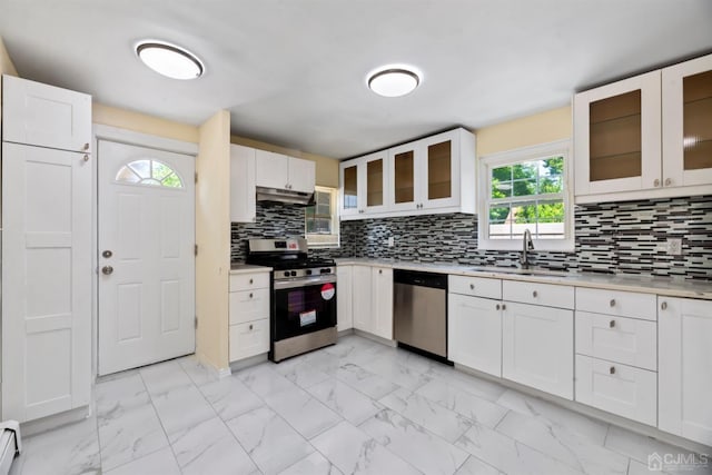 kitchen with a sink, stainless steel appliances, marble finish floor, and under cabinet range hood