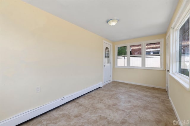 spare room with baseboard heating and baseboards