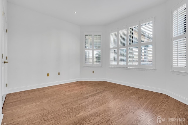 unfurnished room featuring hardwood / wood-style floors