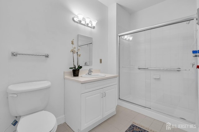 bathroom with vanity, a shower with shower door, and toilet